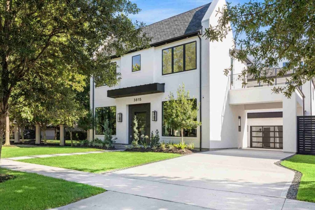 Modern white two-story home with driveway