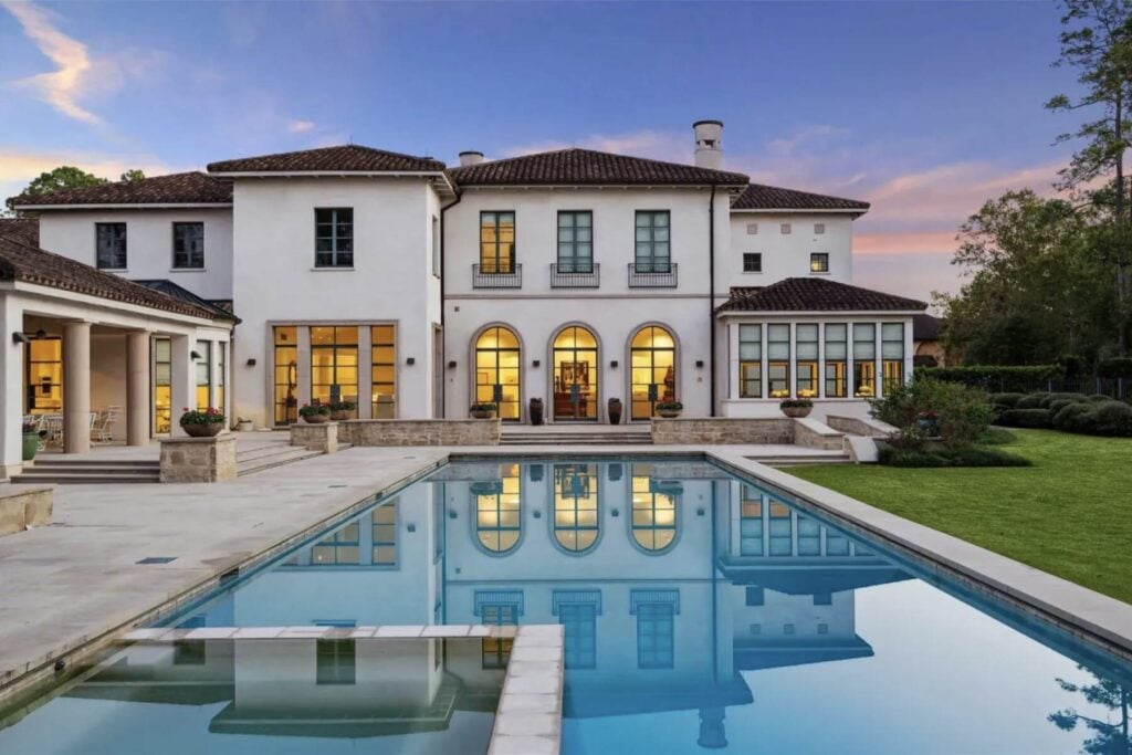 Luxury home with pool at dusk