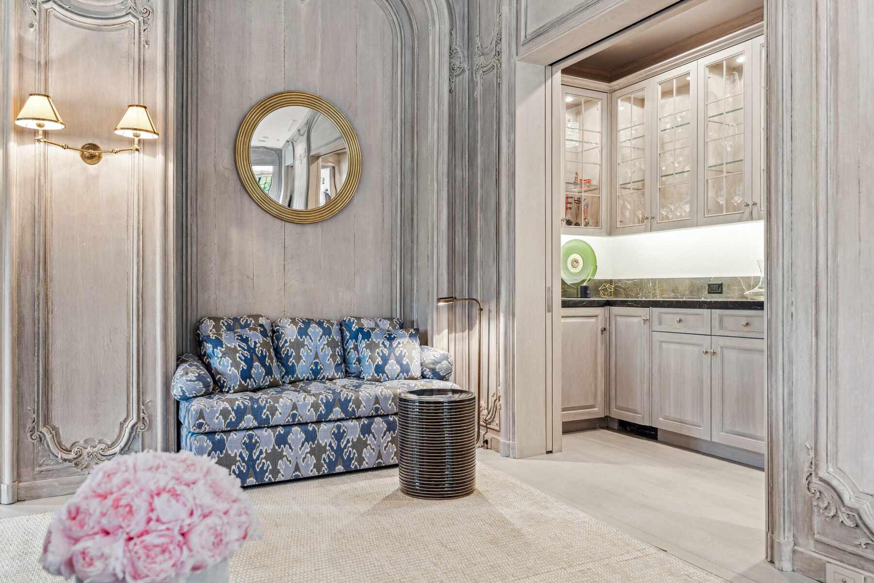 Luxury sitting area with patterned sofa and wet bar