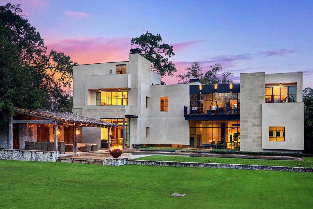Modern luxury home exterior photographed at dusk