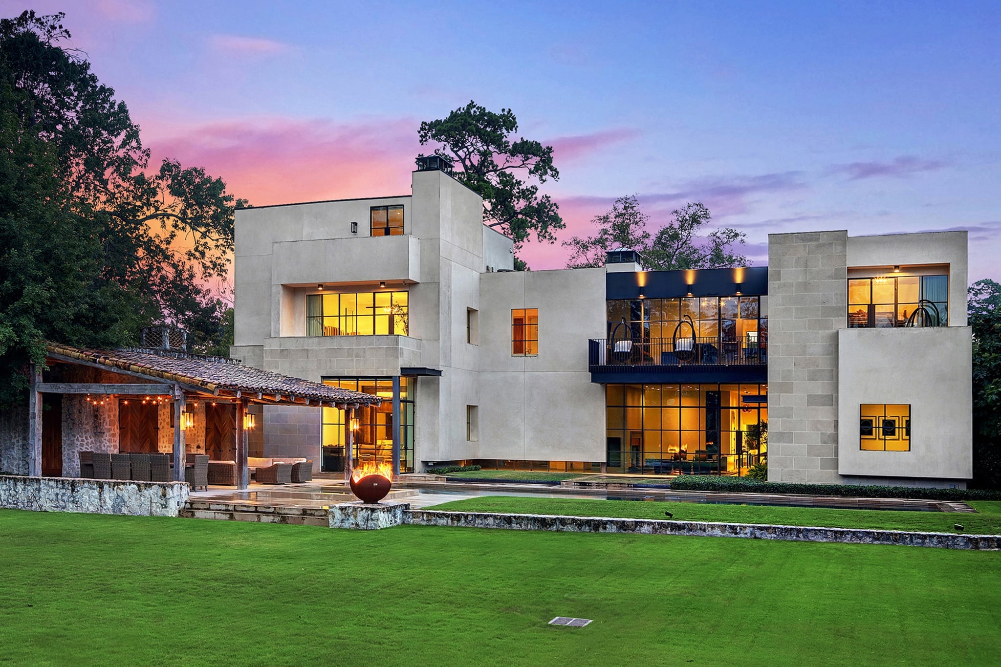 Modern luxury home exterior photographed at dusk
