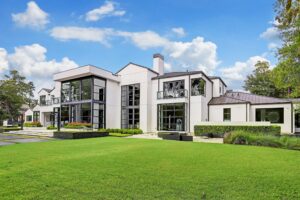Contemporary white model home with landscaped lawn