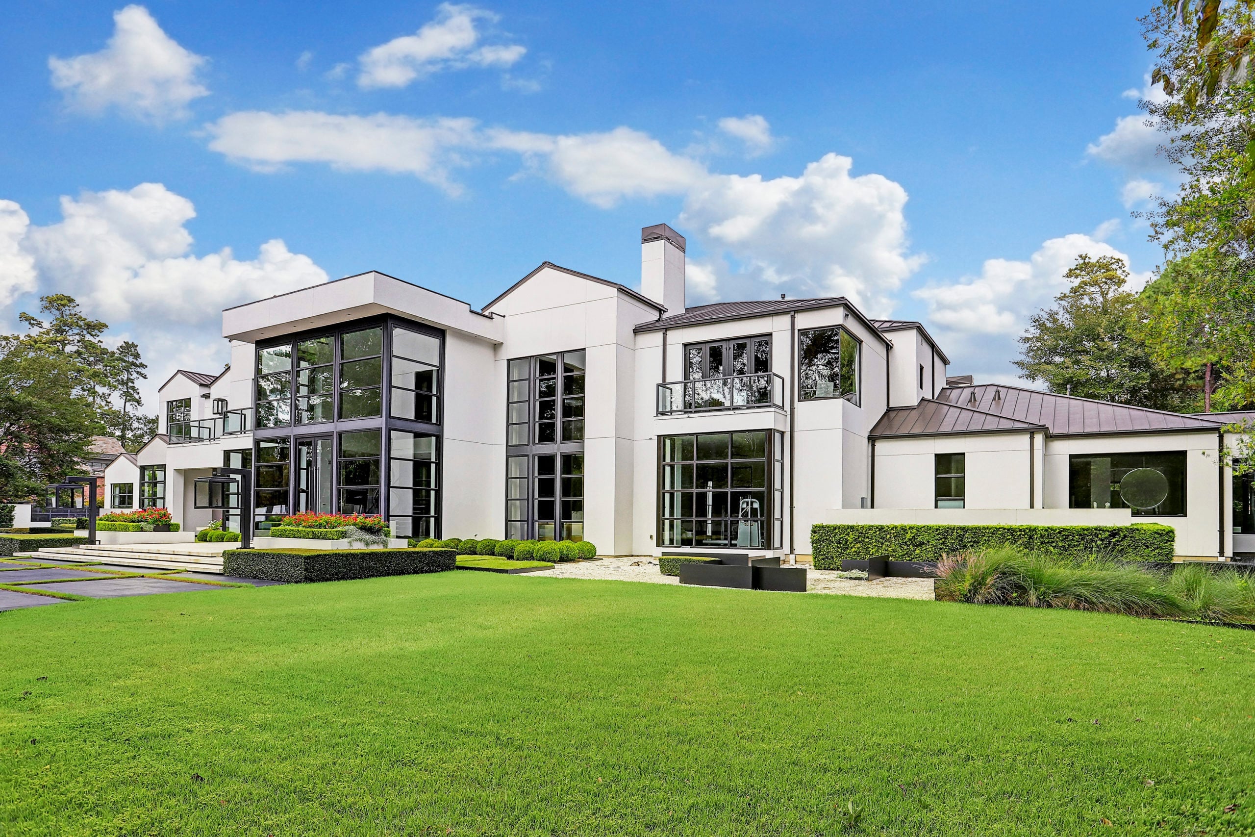 Contemporary white model home with landscaped lawn