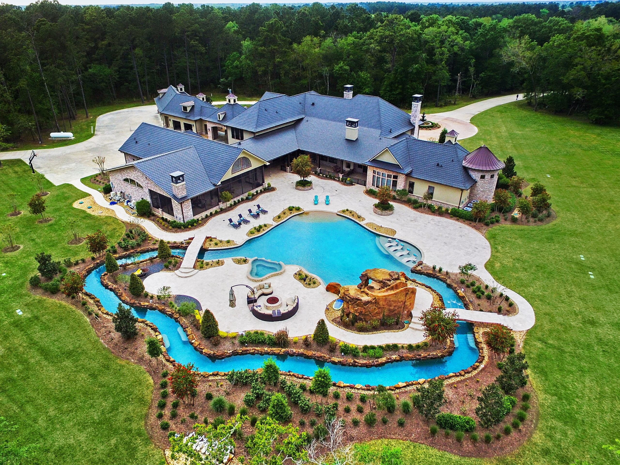 Aerial view of luxury estate with pool and grounds