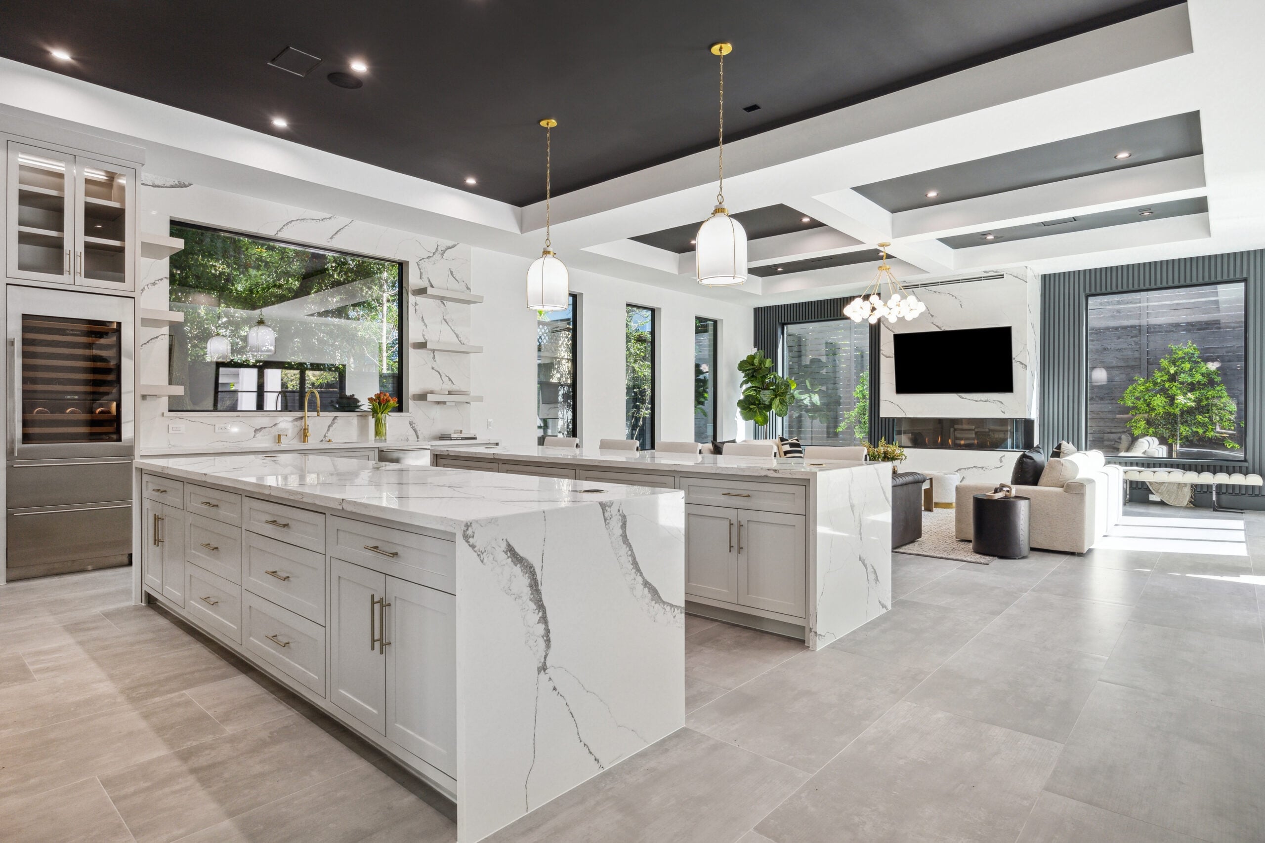 Open-concept kitchen and living room with marble finishes