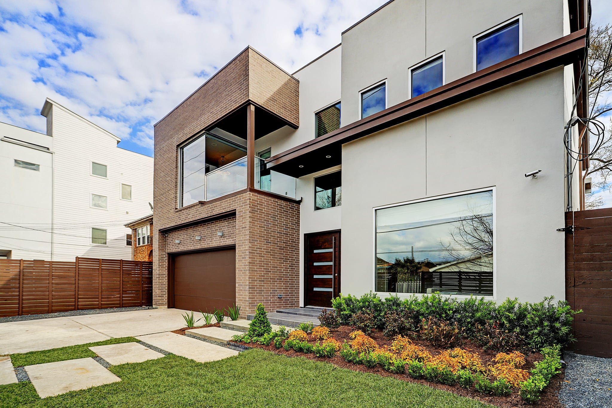 Modern new construction home with brick and stucco exterior