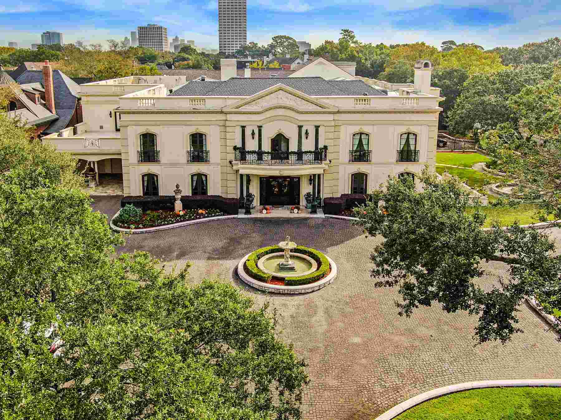 Aerial view of a luxury estate with courtyard fountain