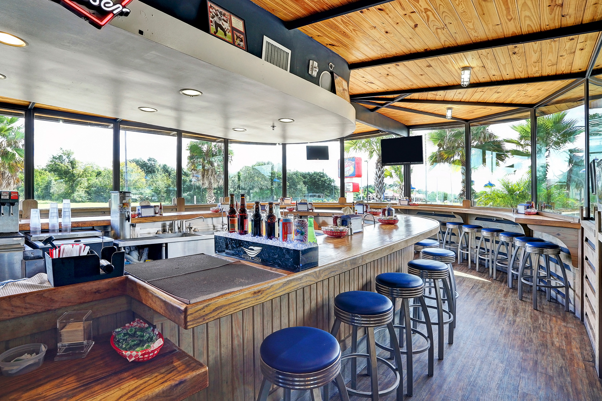 Bright restaurant bar with wraparound seating and large windows
