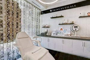 Modern skincare treatment room with product displays and treatment chair